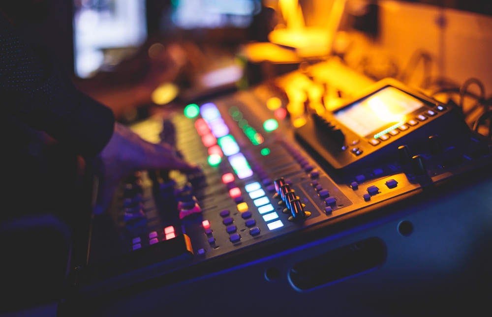 View,Of,Lighting,Technician,Operator,Working,On,Mixing,Console,Workplace